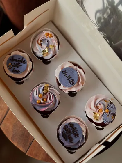 A beautiful set of cupcakes for a bridal shower. I used a mix of delicate frosting swirls, edible gold leaf, and custom fondant plaques with the wedding date to create an elegant look.