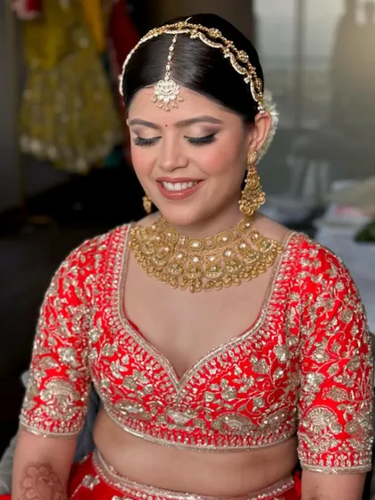 A close-up of the bride's wedding day glam. The soft gold eyeshadow, winged liner, and glowing skin are the key elements of this beautiful look.