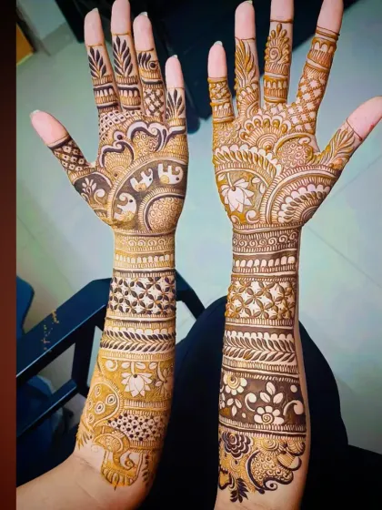 A clear, bright shot of the intricate elephant and peacock mehandi, showing the fine details in the artwork.