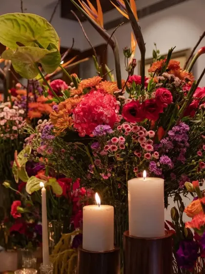 A detailed shot of the colorful centerpiece, showing the interplay of different flower shapes and textures. The composition is both wild and meticulously balanced.