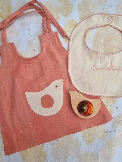 This newborn gift set is a collaboration with a like-minded women entrepreneur. It features a naturally hand-dyed Kora cotton dress with an applique inspired by our toys, paired with a safe, natural-dye Channapatna rattle.