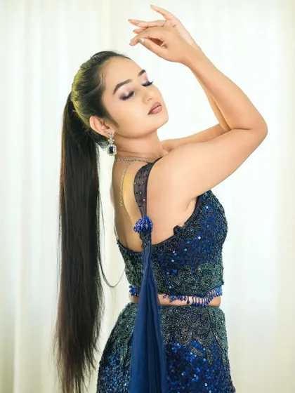A modern take on ethnic wear, this blue sequined crop top and skirt set is a fantastic choice for a contemporary sangeet or reception look.