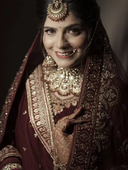 A happy and engaging portrait of the bride, looking directly at the camera with a genuine smile.