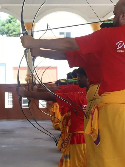 Students of all body types learn to adapt the techniques to their own strength. Here, a student receives guidance on his draw, ensuring he builds power and accuracy safely.