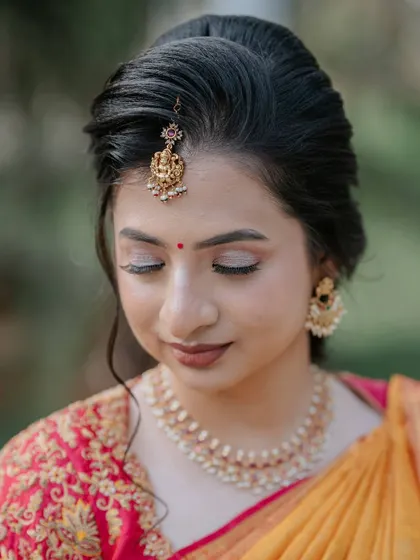 A detailed close-up of the eye makeup and traditional bindi. I used soft, neutral shimmers to create a look that is both classic and captivating.