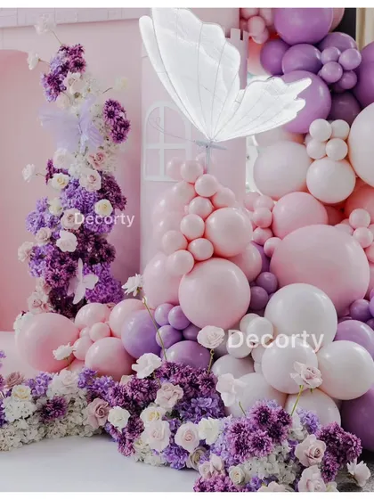 A detailed shot of the balloon and flower arrangement, highlighting the glowing butterfly accent.