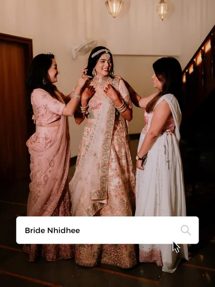 A sweet moment of the bride getting help with her jewelry from her loved ones.