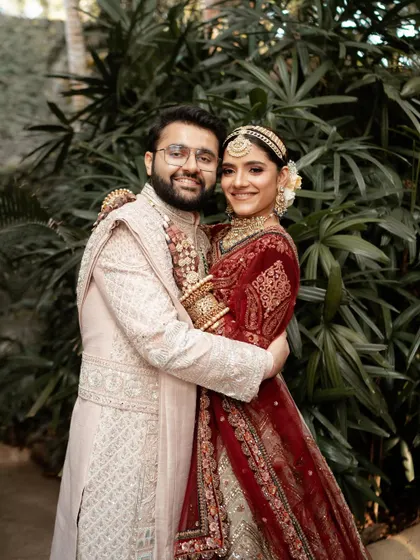 A joyful, classic portrait of the happy couple, embracing and smiling for the camera.