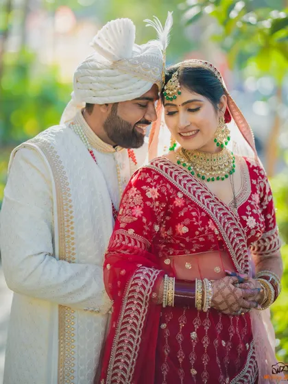An intimate portrait of a Sindhi couple, their faces close together, capturing the love and happiness of their wedding day.
