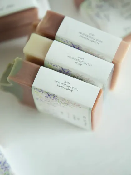 Custom lavender and sage-themed soaps made for a baby shower. The wrap-around labels were designed to match the special day's decor.