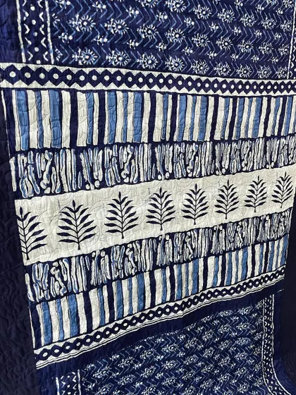 A detailed shot of the block-printed pallu used in a custom saree quilt.