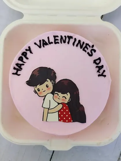 A cute couple illustration on a pink bento cake for Valentine's Day.