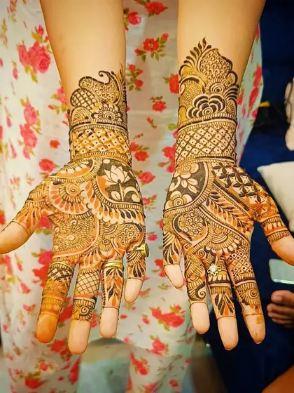 This design shows the beautiful orange-brown stain of the henna a day after application. The floral and lotus patterns have developed a rich color.