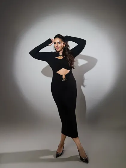 A different pose, same powerful energy. This shot highlights the fit of the dress and Huma's confident presence.
