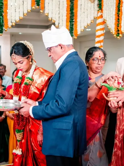 The couple receiving blessings and gifts from their elders after the main ceremony, a moment of respect and tradition.