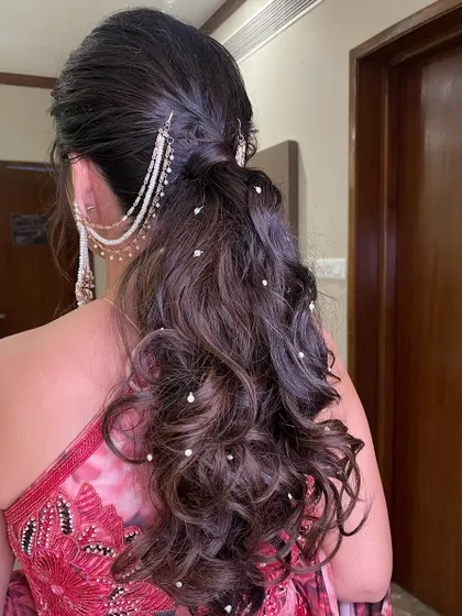 A back view of the pearl-studded messy ponytail.