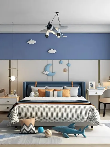 A boy's bedroom with a cool nautical and aviation theme. The blue accent wall, airplane light fixture, and cloud decor create an adventurous and fun atmosphere.