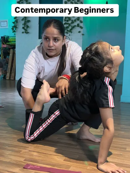 A close-up of a student in a deep backbend stretch. Her focus and determination are inspiring.
