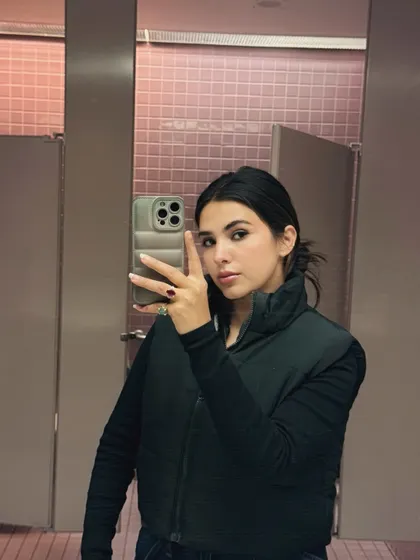 A casual college look featuring a black puffer vest for a comfy and practical OOTD.