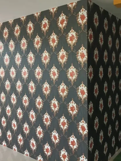 A classic damask wallpaper installed in a salon. The dark, repeating pattern adds a touch of luxury and sophistication.