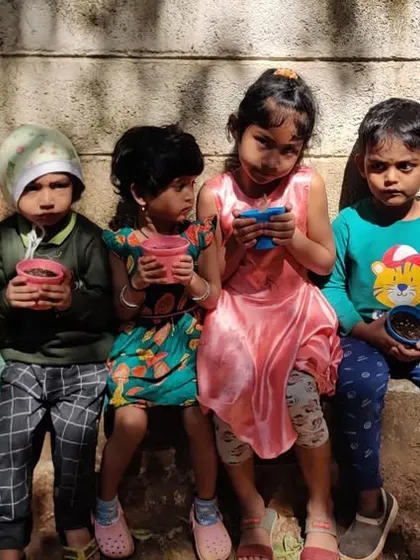 As part of our Green Day celebration, children sat outdoors with pots to sow chili seeds. This activity teaches them about the life cycle of plants and the patience required to nurture something and watch it grow.
