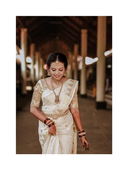 A serene portrait of the bride walking through a corridor, her expression thoughtful.
