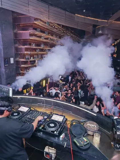 A high-angle view of the DJ booth, showing the scale of the party. I work with a VJ to sync the visuals and effects perfectly with the music.
