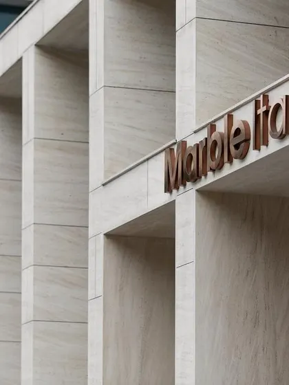 The 'Marble Italia' branding is seamlessly integrated into the facade of Stone Boulevard. This detail demonstrates how we consider every element, from the grand structure down to the signage, as part of a cohesive architectural identity.