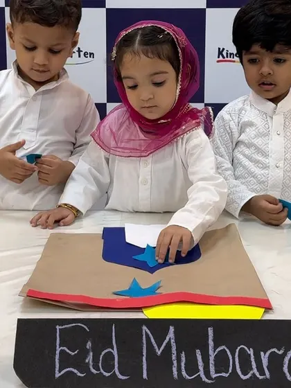 Children carefully decorate a mosque craft for Eid. This hands-on activity helps them learn about the cultural symbols associated with the festival.