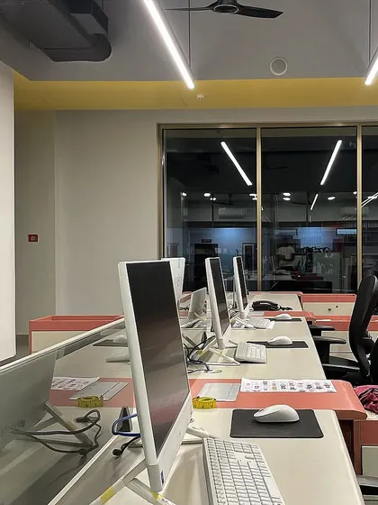 A close-up of the computer workstations, highlighting the clean and organized setup designed for a productive workflow.
