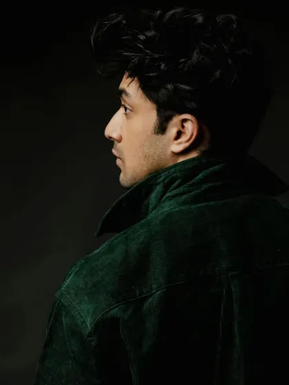 A profile shot of Lakshya Parikh in the green corduroy jacket.