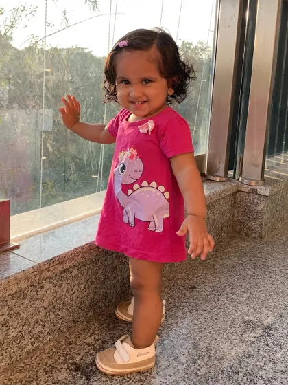 My little girl posing in her cute dinosaur dress.