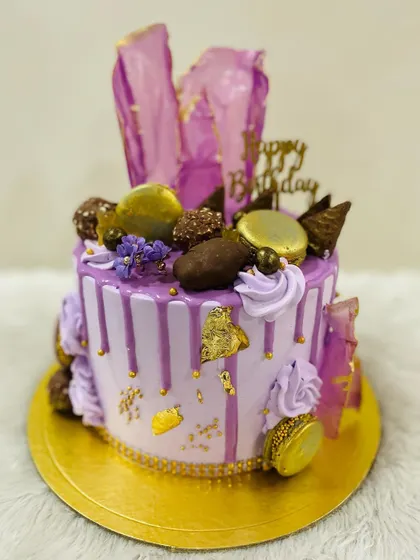 A close-up of the rich toppings on the lavender drip cake.