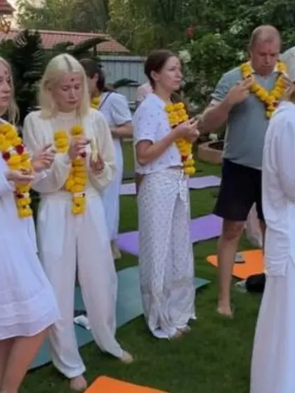 Students stand together on their yoga mats during the opening ceremony in Goa, ready to begin their practice as a unified group.