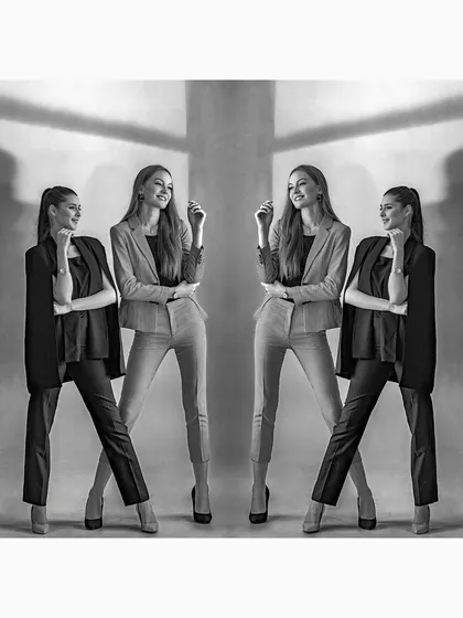 A stylized, symmetrical black and white photograph of models in corporate suits. This image is a creative take on business fashion, playing with reflections and shadows.