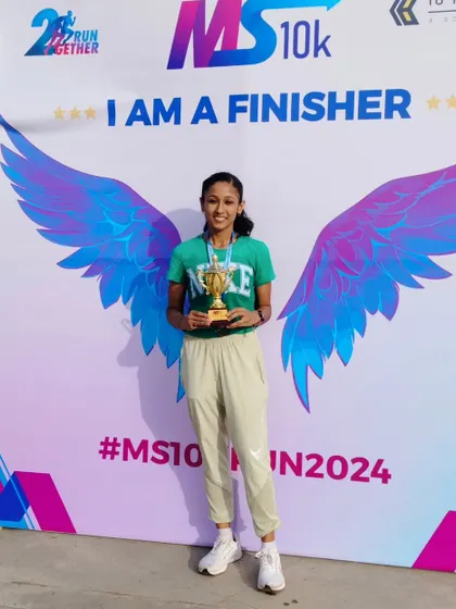 I am a finisher. Holding my trophy after a 10k personal best. Once you know what failure feels like, you start chasing success with everything you've got.