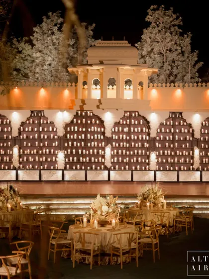 The stunning candle wall at the 'Muted Melodies' sangeet. Thousands of candles lit up the muted design, creating a warm, contemporary, and luxurious backdrop for the couple to dance the night away.