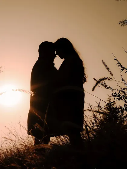 A classic silhouette shot of Ankit and Shreya against the setting sun in Shimla, creating a timeless and romantic image.