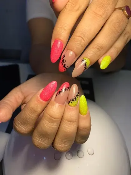 A fun and edgy design with neon yellow and pink nails and black Dalmatian-spot accents.