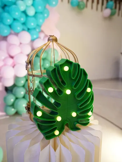 A monstera leaf marquee light, ideal for adding a tropical touch to a jungle or mermaid theme.