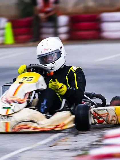Our driver in the number 75 kart, pushing hard in tricky, wet conditions.