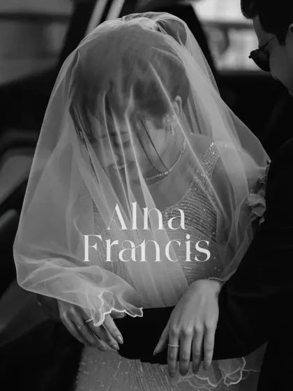 A beautiful, artistic shot of the couple through the bride's veil. This black and white image is intimate and romantic, focusing on their close connection.