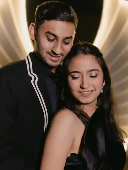A romantic shot of the couple. Her soft glam makeup with subtle shimmer on the eyes looks beautiful in the warm, ambient lighting.