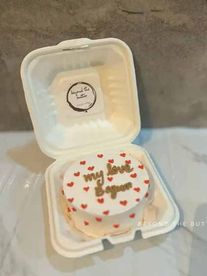 "My love begun." A romantic message on a heart-studded bento cake, perfect for an anniversary or just because.