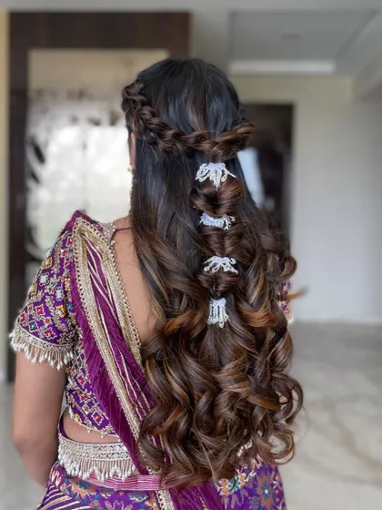 A still shot of the intricate half-updo with multiple braid types and accessories.