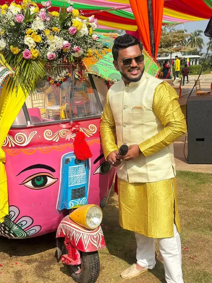 Posing with a colorful auto-rickshaw prop. I love venues with fun, quirky decor.