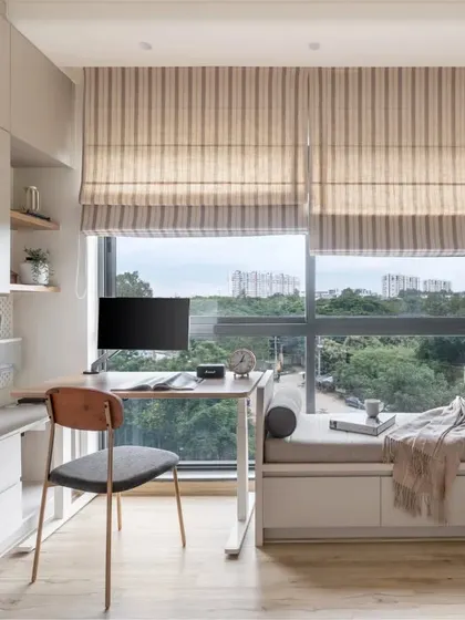 My designs turn every corner into a useful and beautiful space. This multifunctional room combines a cozy bay window seat with a streamlined study nook, complete with custom wicker-paneled wardrobes, showcasing my approach to smart, space-saving solutions.