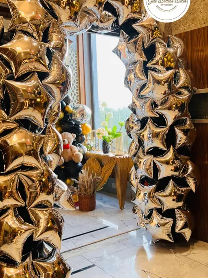 A unique entrance arch made entirely of silver star-shaped foil balloons for a star-studded 18th birthday.
