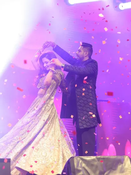 A magical twirl under a shower of confetti. I use stage effects like these to elevate a couple's first dance and create a truly cinematic and memorable sangeet experience.