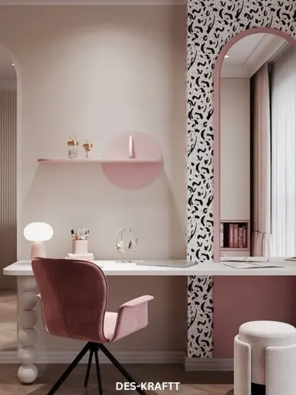 The vanity and study area in this room is both chic and playful, with a unique desk supported by spherical legs and an arched mirror with a fun, abstract border.